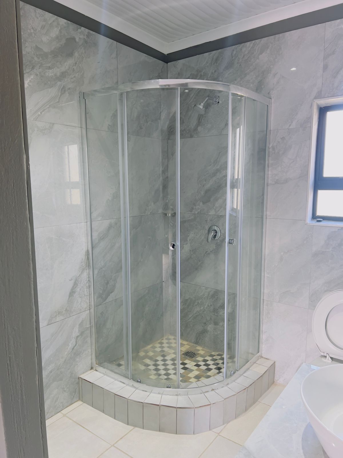 Modern en-suite bathroom with glass shower