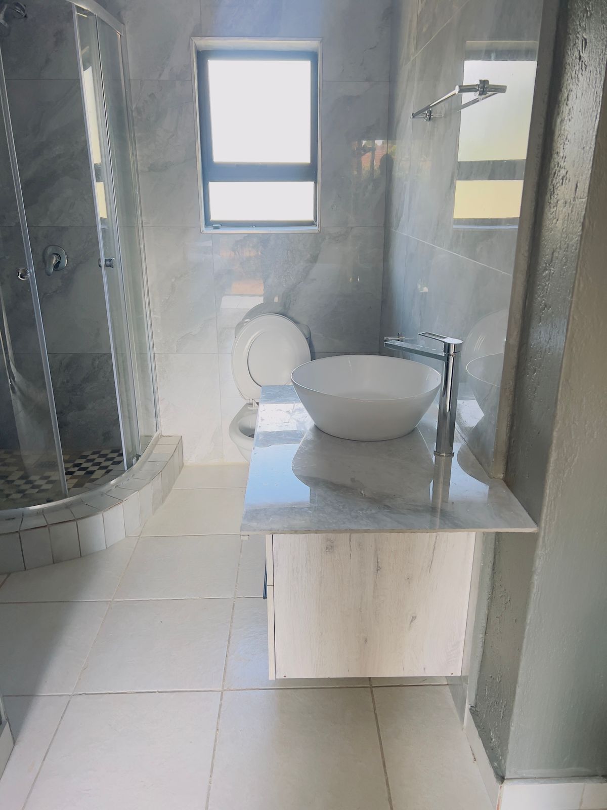 Stylish bathroom with vessel basin and marble finish